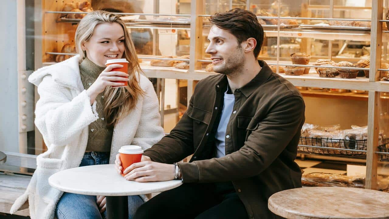 A couple talking over coffee