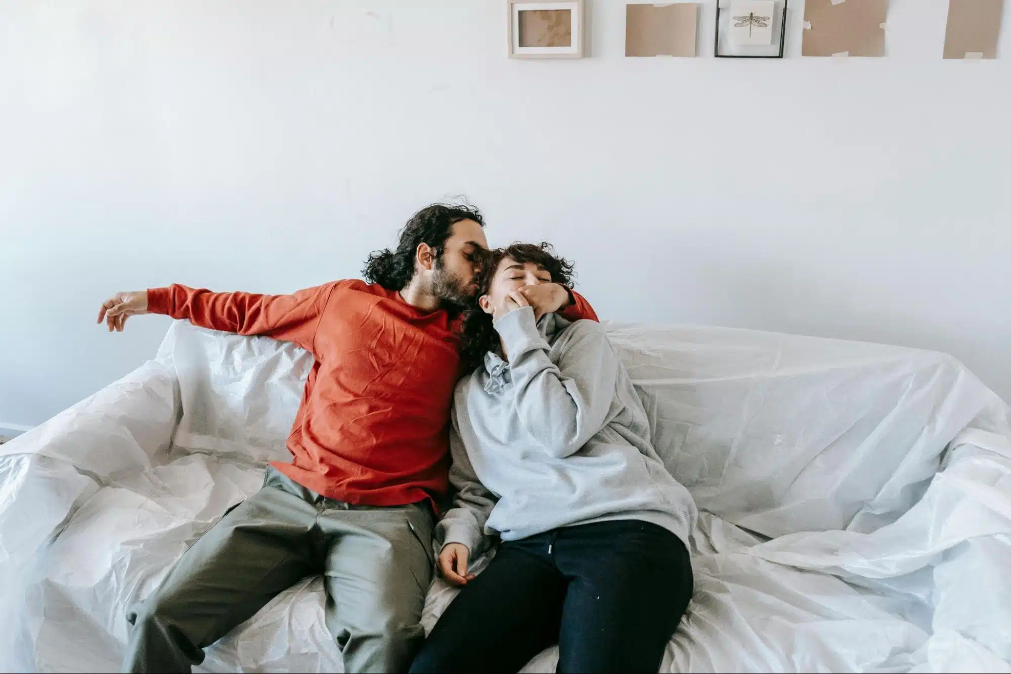 A man kissing a woman’s head