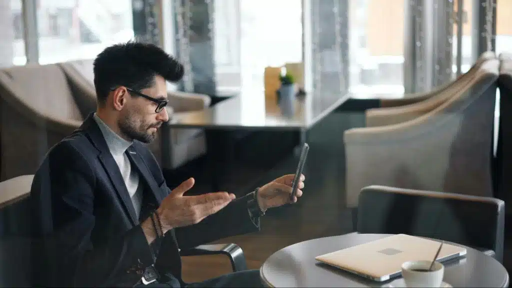A man video calling with someone over the phone
