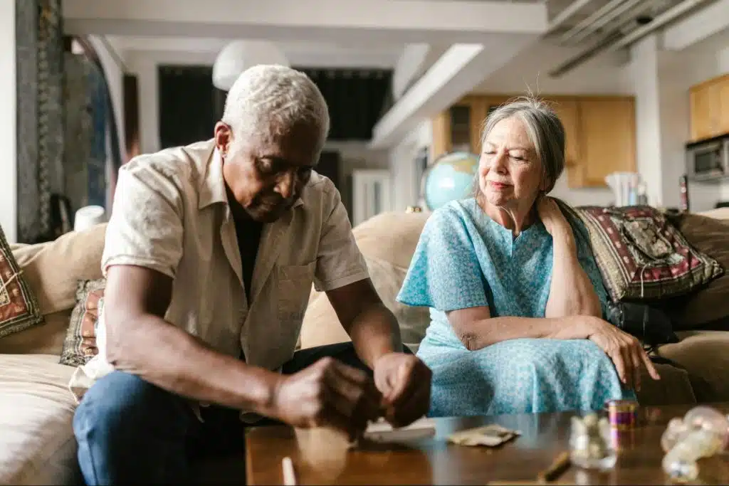 A man looking sad and a woman looking at him