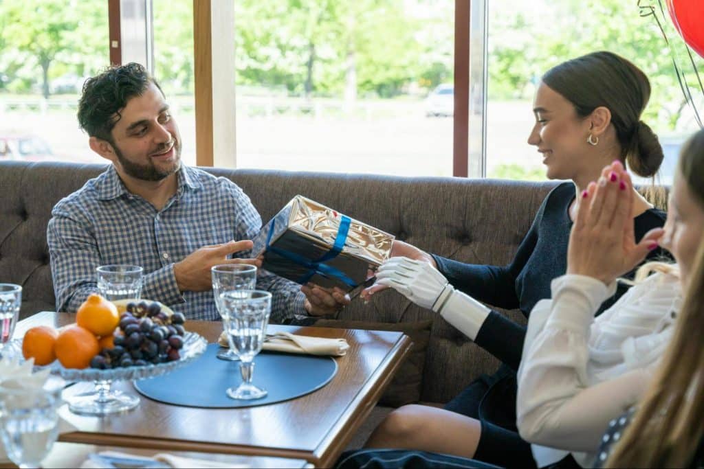 A woman receiving a gift from a man 