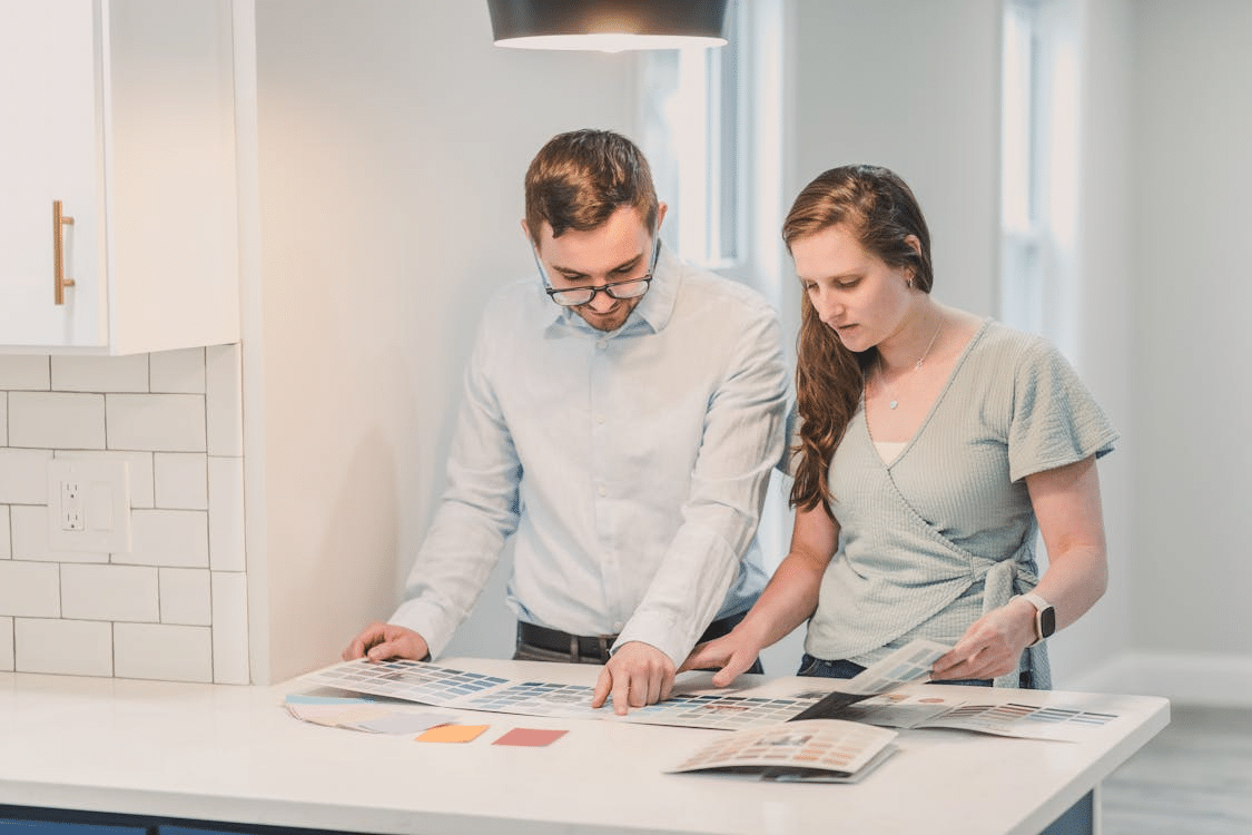 A couple browsing a paint brochure