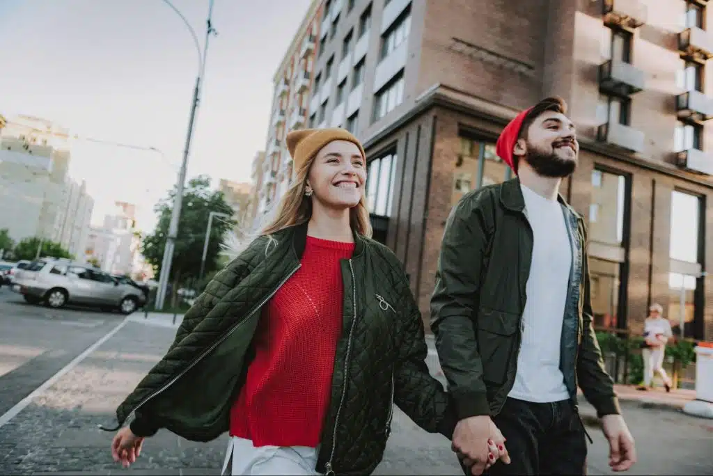 A man and woman walking and holding hands