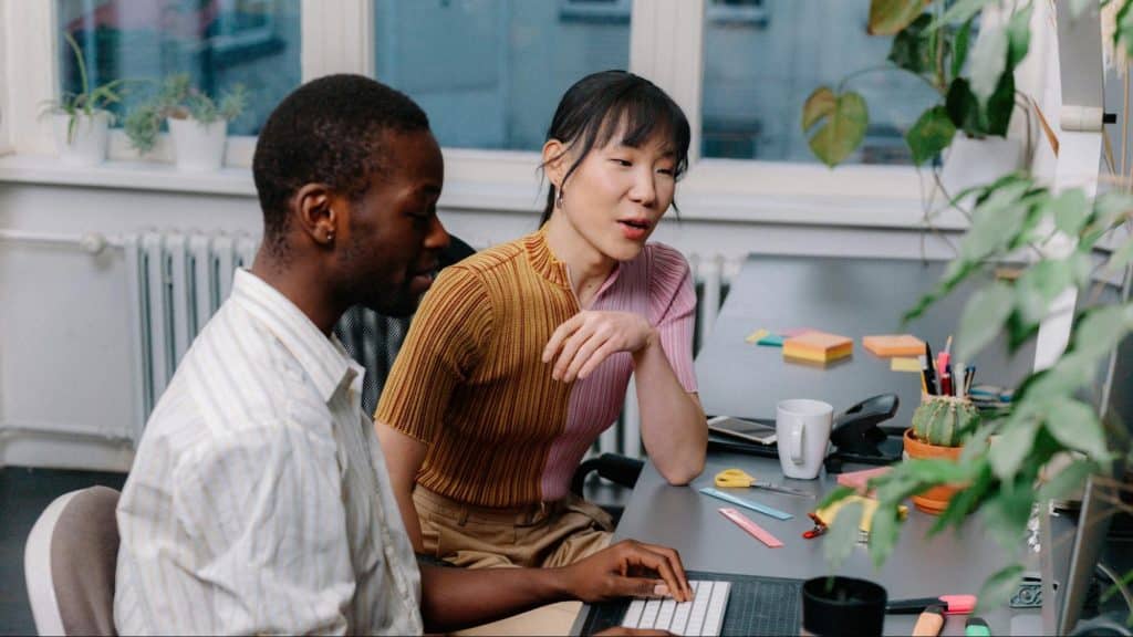 A woman trying to speak with a busy man