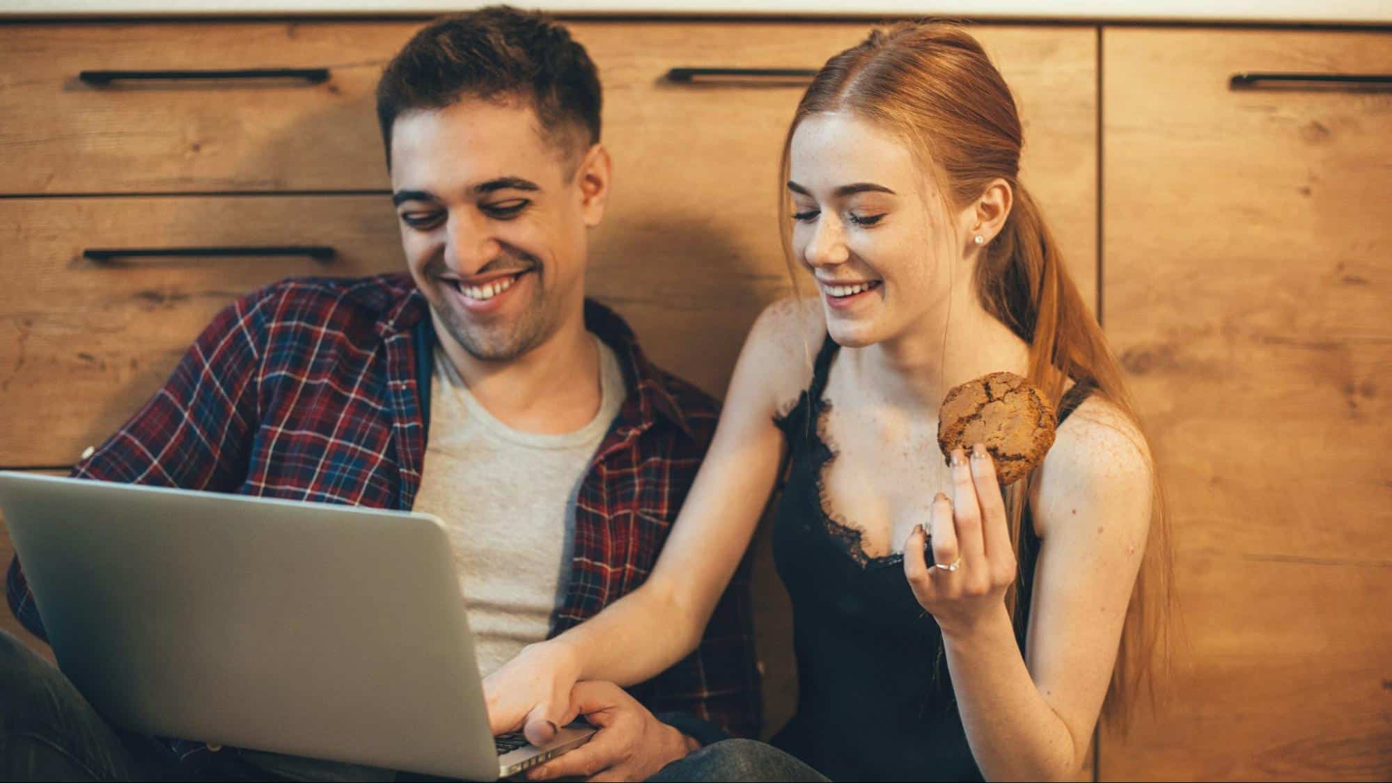 A man and woman using a laptop