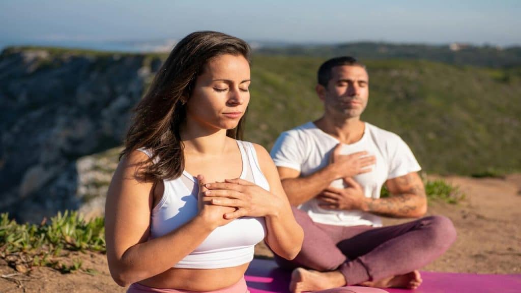 A man and a woman doing yoga