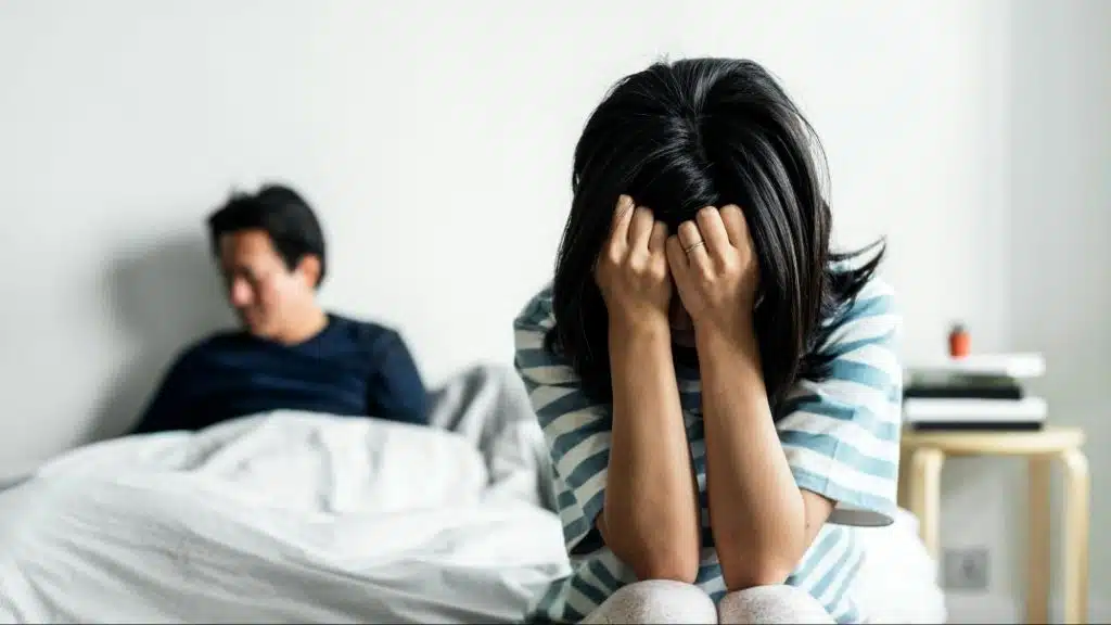 A woman covering her face because of sadness 