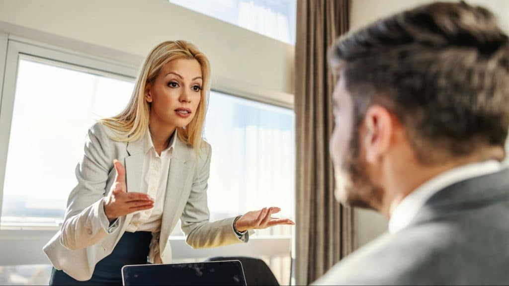 A woman trying to speak with a man