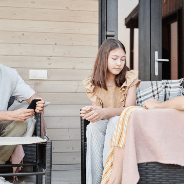 A family sitting on a patio