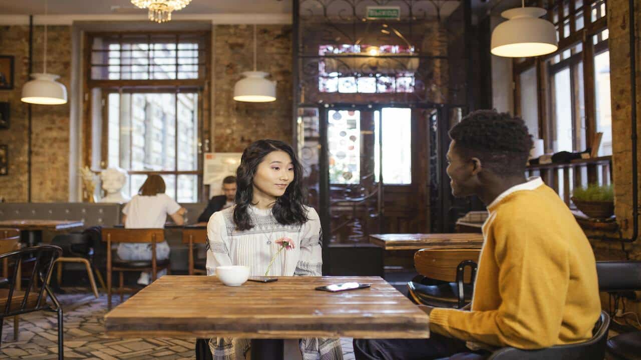 A couple talking at a restaurant