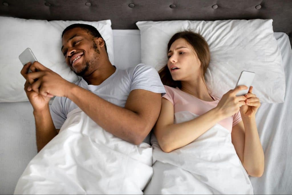Woman looking at the man’s activity
