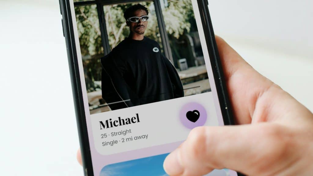 A man holding a phone with his profile on a dating apps
