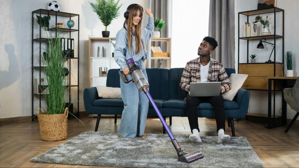 A man letting a woman to clean the house without offering help