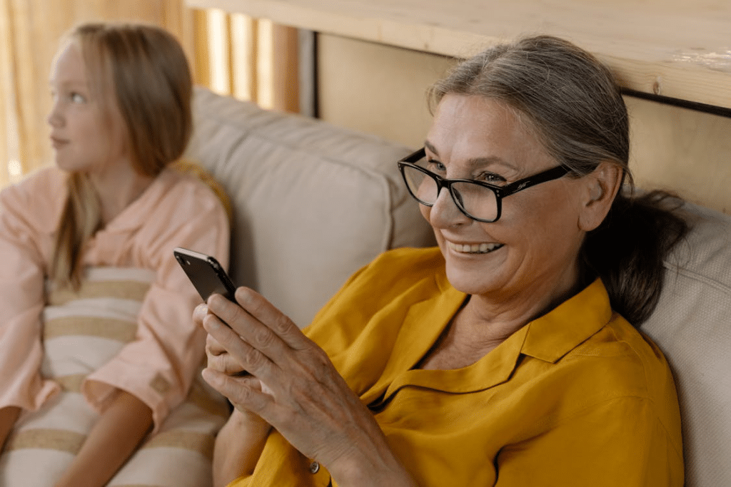 Close-Up Shot of an Elderly Woman while Holding a Smartphone