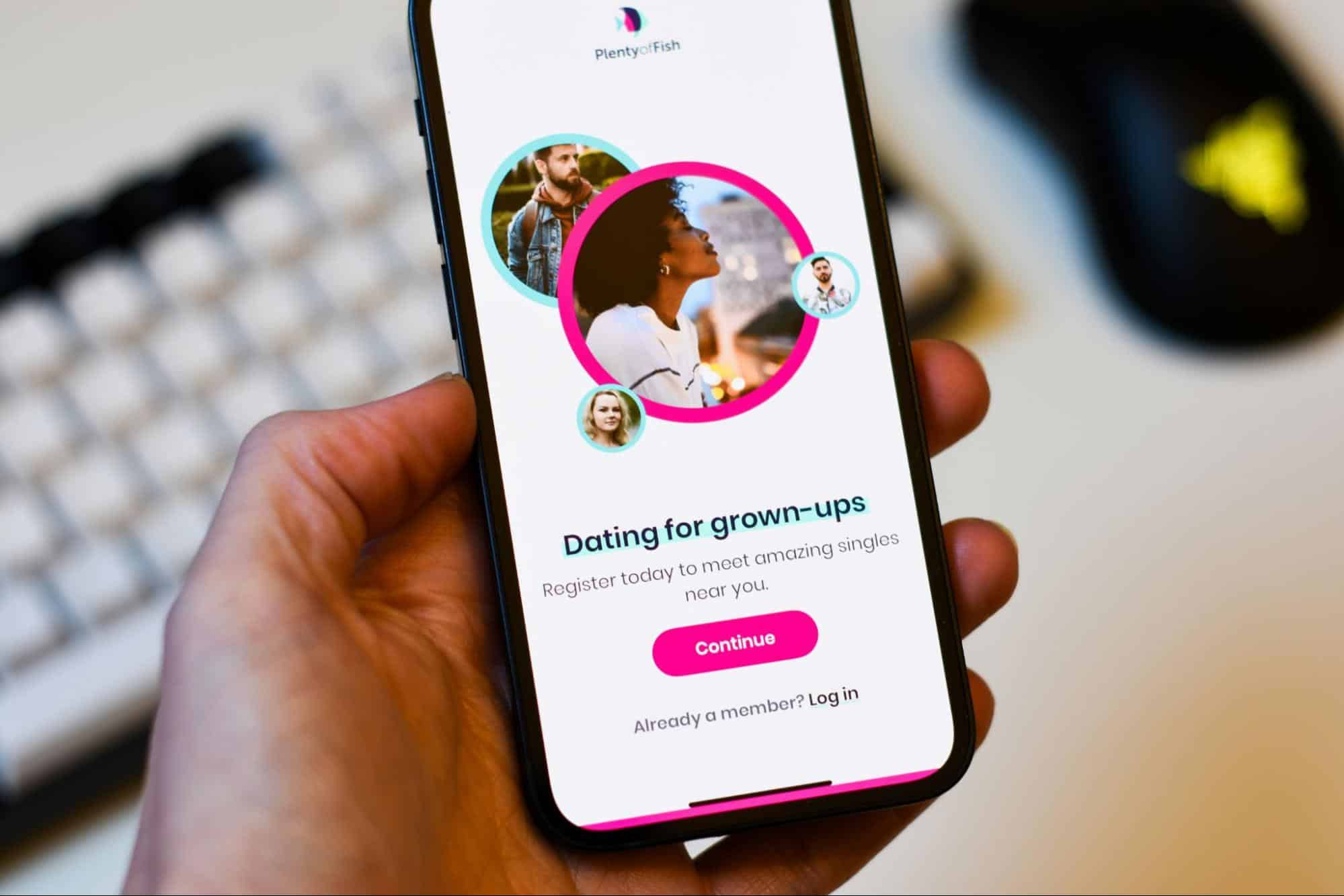 A picture of a person holding a phone with dating-apps on it