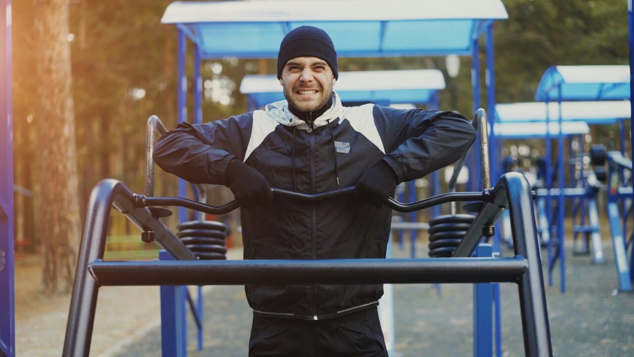 A man smiling while exercising