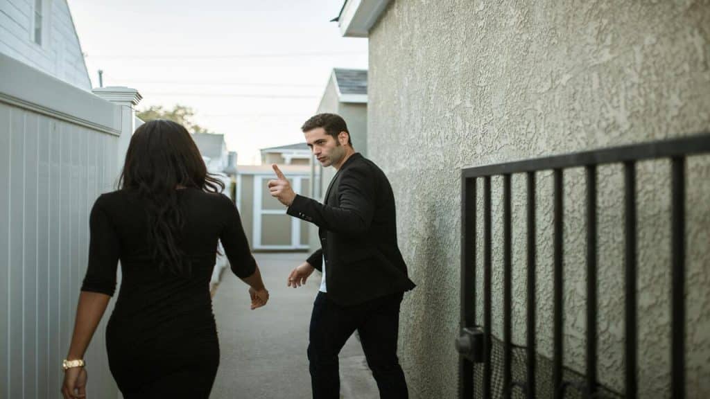 A couple fighting outside their home