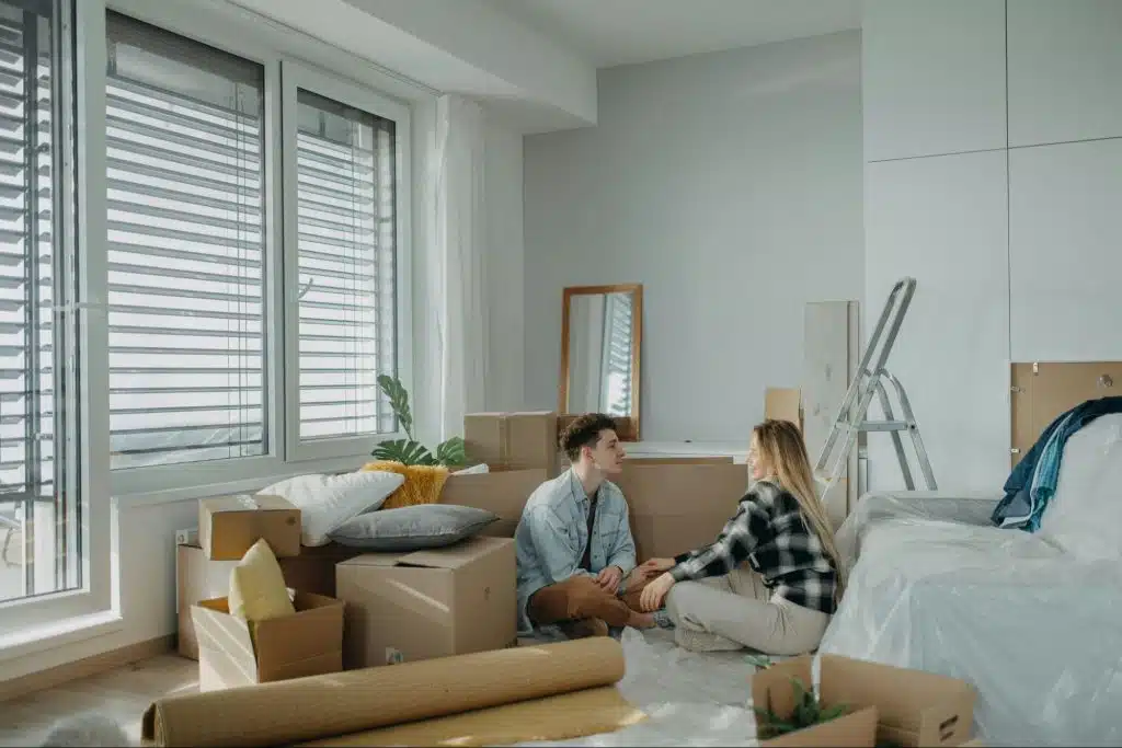 A man and woman sitting on the floor