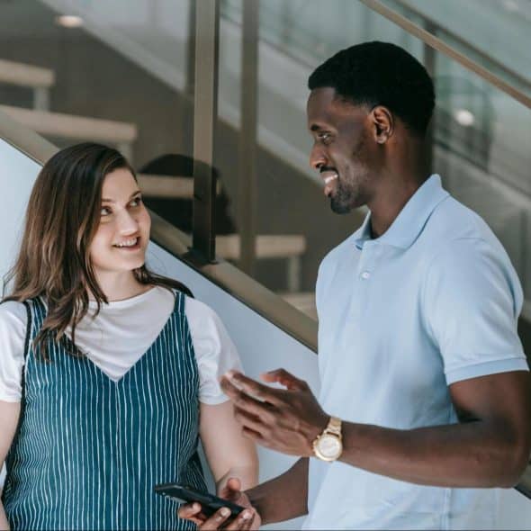 A man and woman smiling at each other