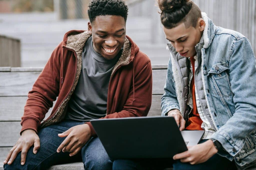 Two men looking at the laptop