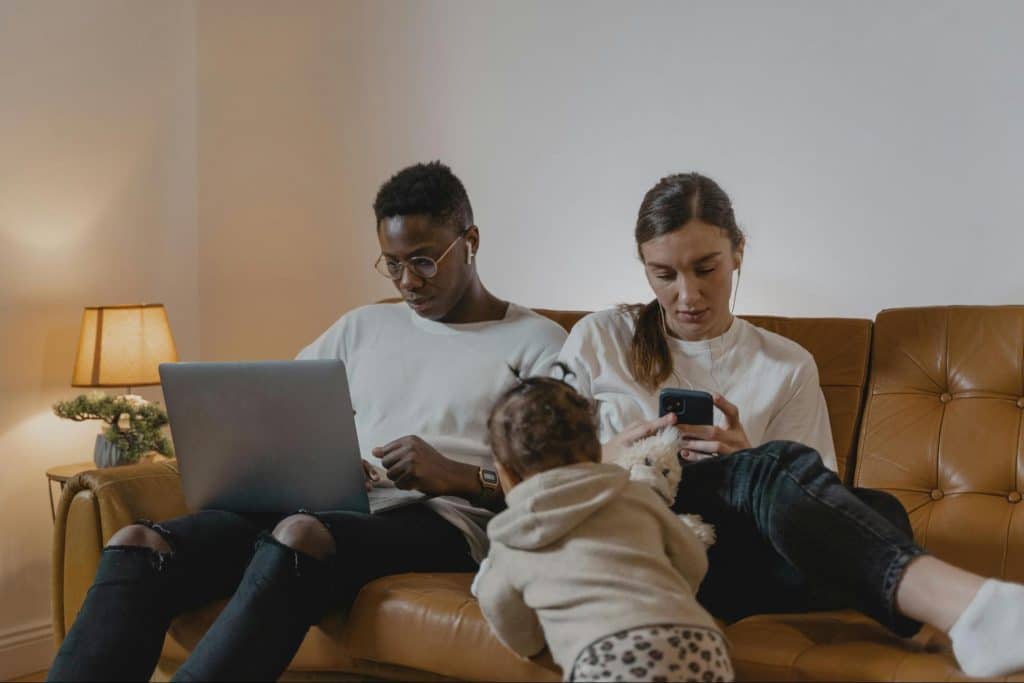 A man busy working beside his family