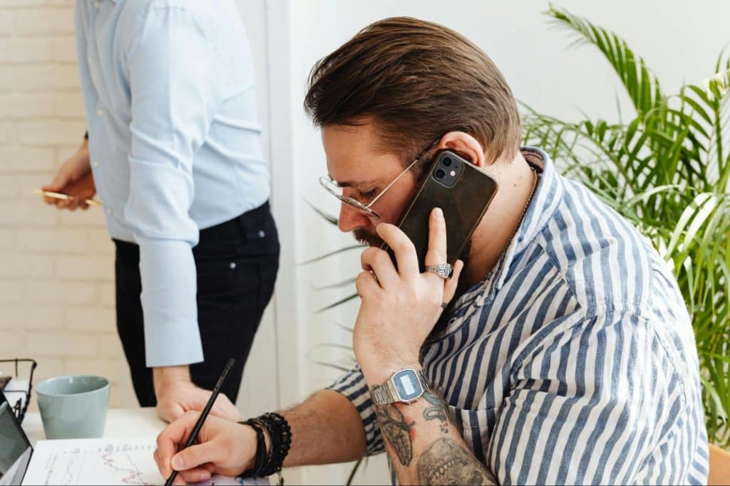 A man talking with his wife over the phone