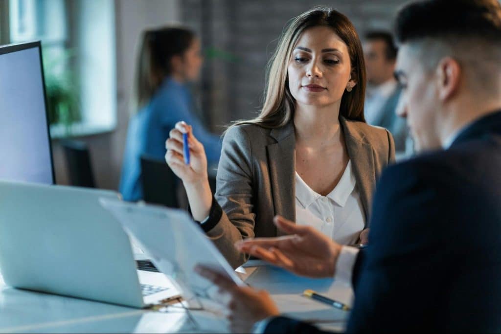 A woman planning and a man listening to her