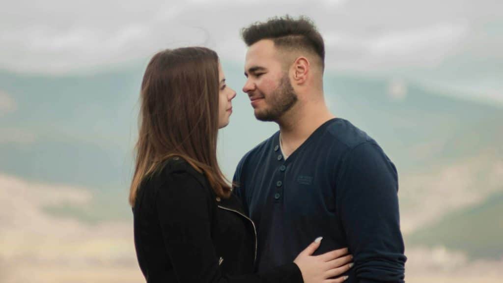 A couple looking at each other and smiling.