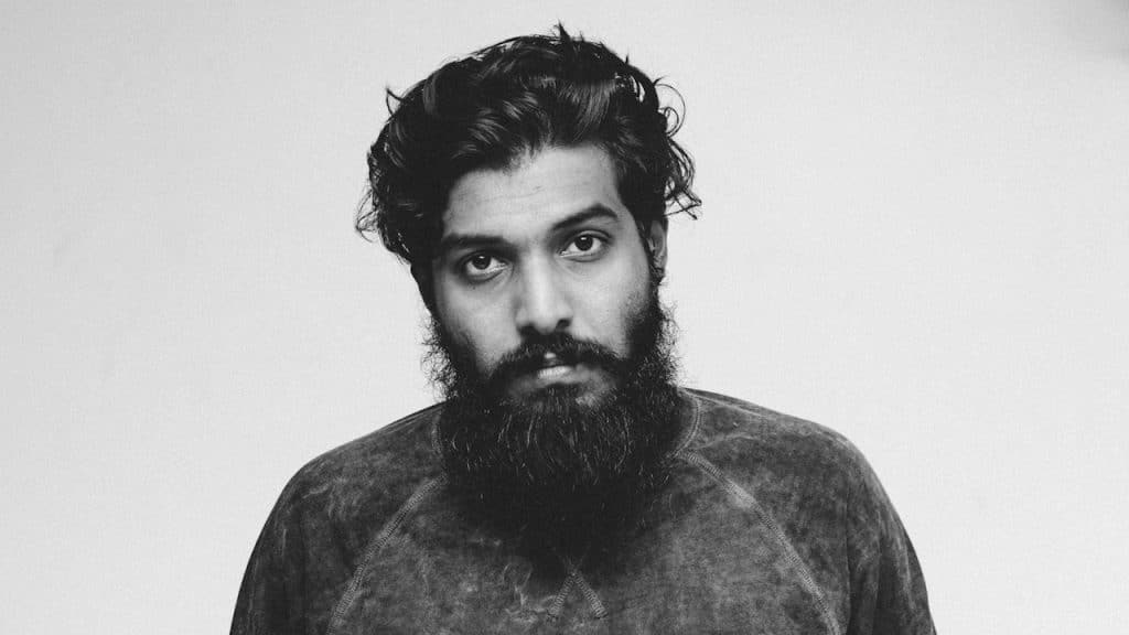 A bearded man looking at the camera.