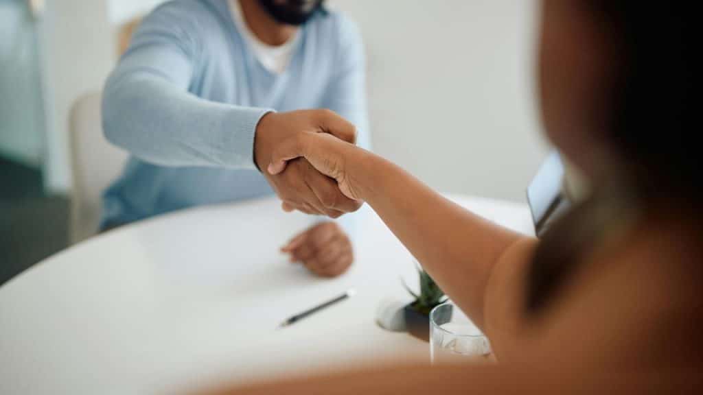 A close-up of two people shaking hands.