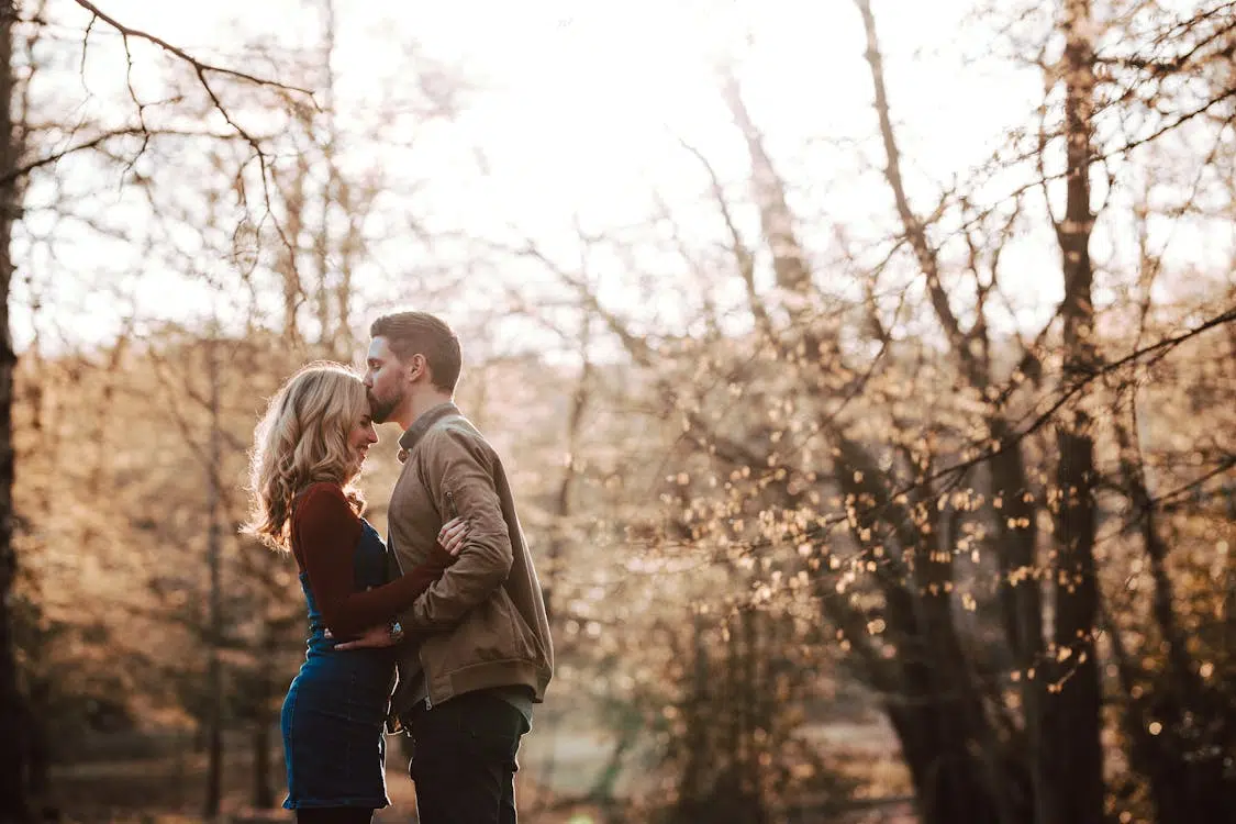 A man forehead kissing a woman