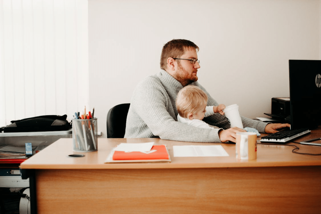 A man working while watching over his child