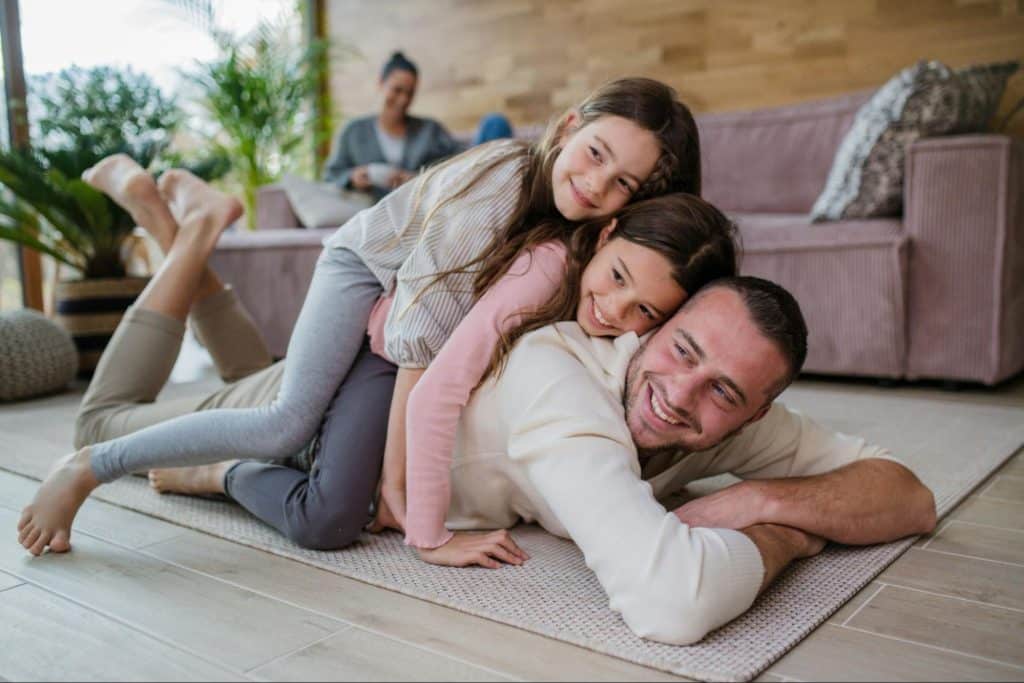 A man entertaining his kids