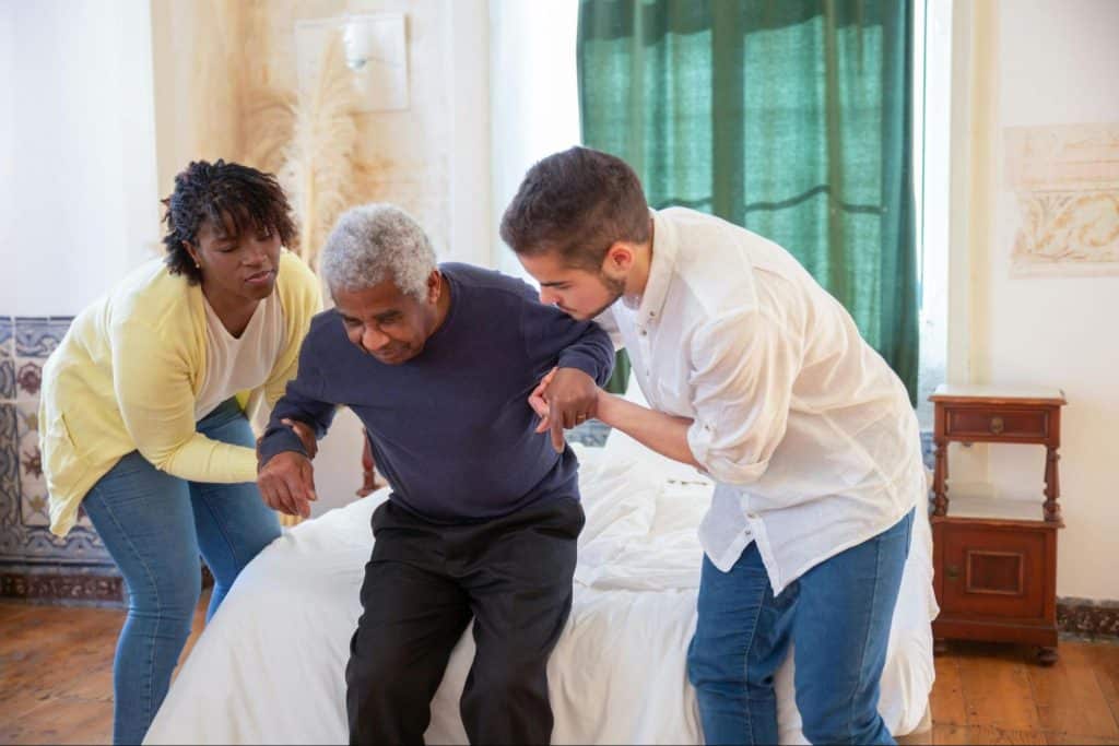 A man assisting an elderly