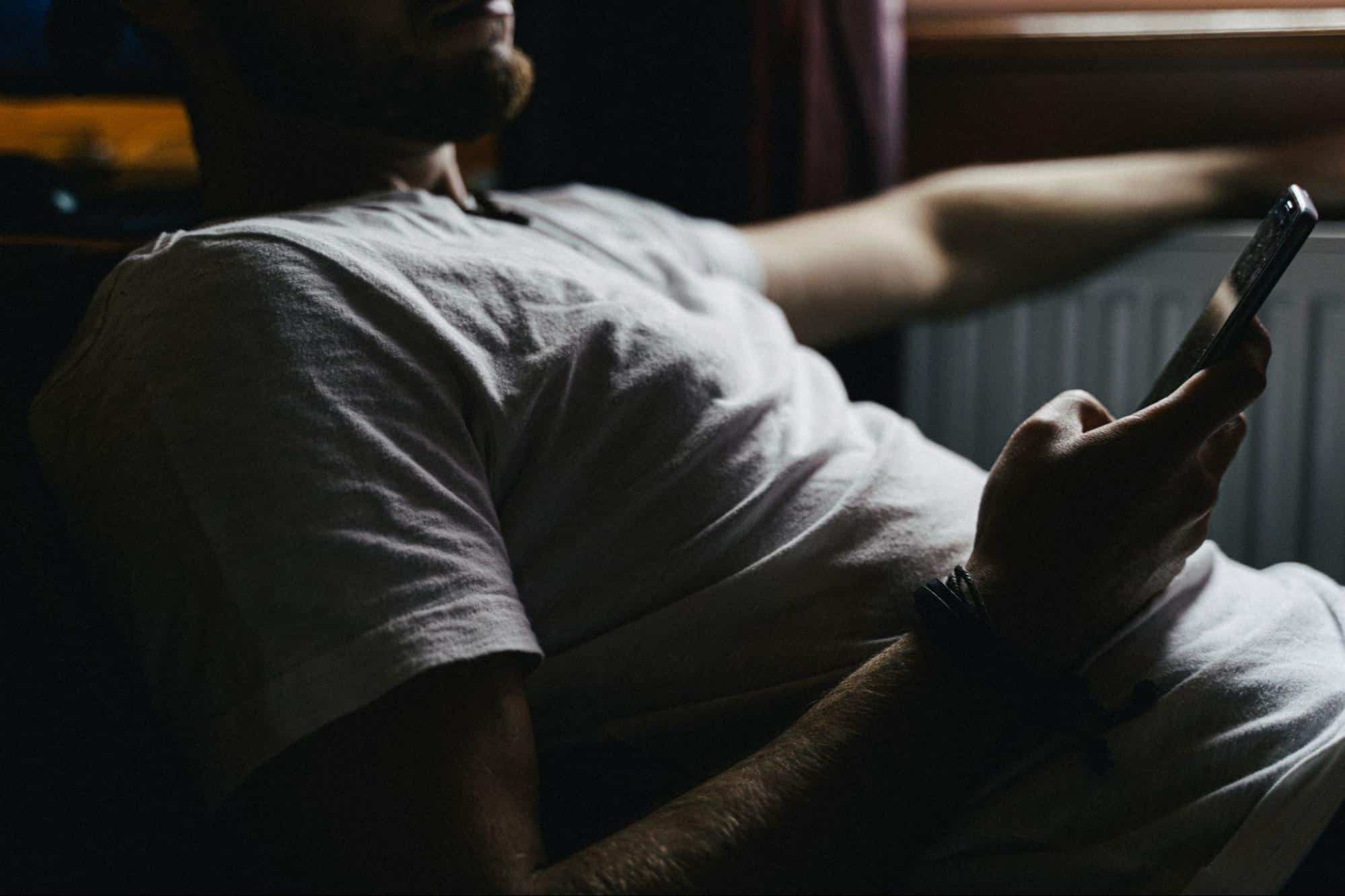 A man scrolling through his phone