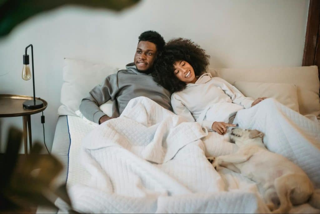 A man and woman at the bed