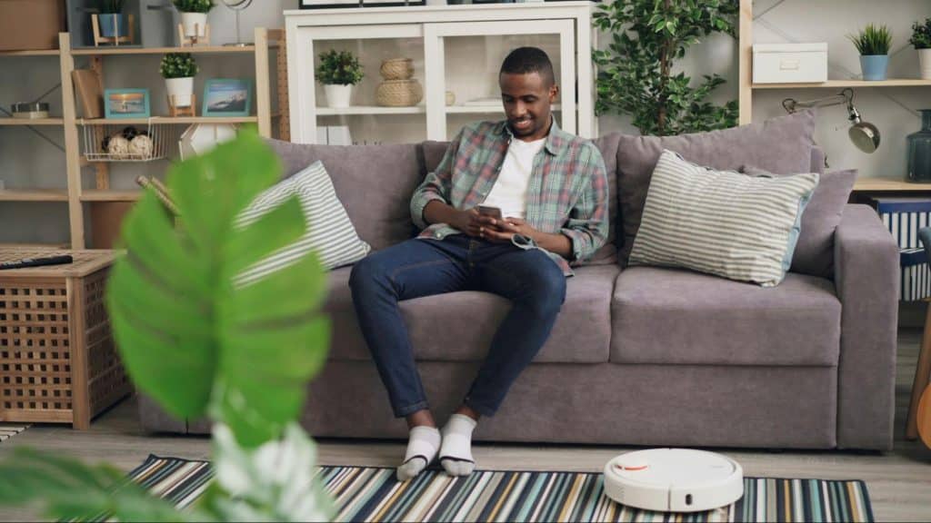 A man smiling while using a phone