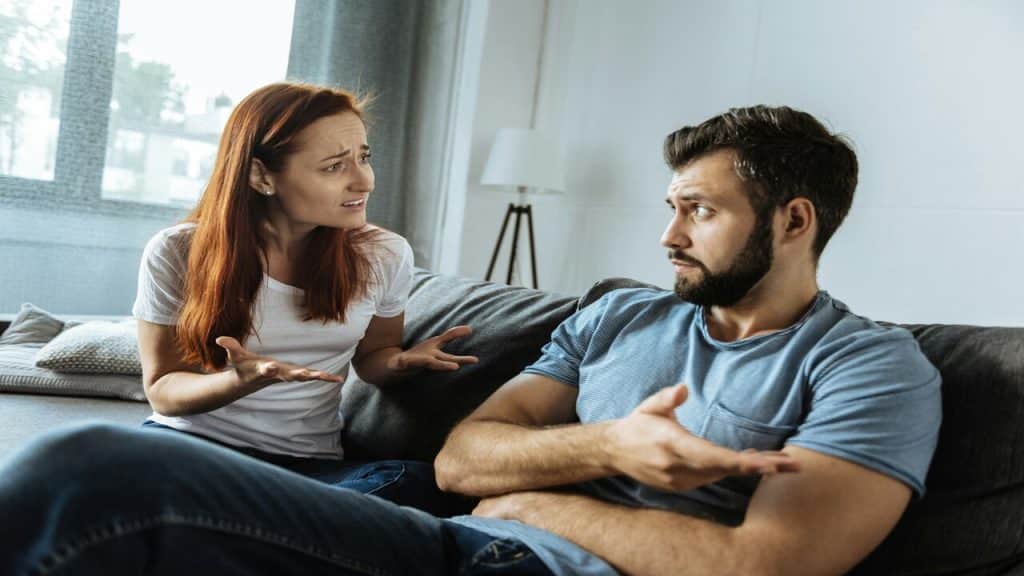 A couple disagreeing in the living room