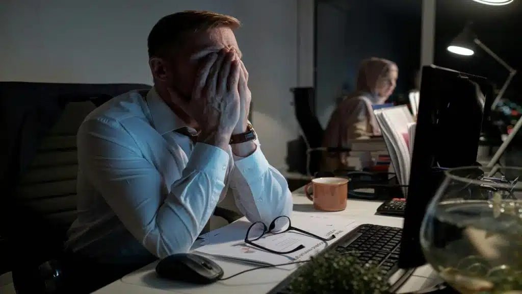 A man looking stressed at work
