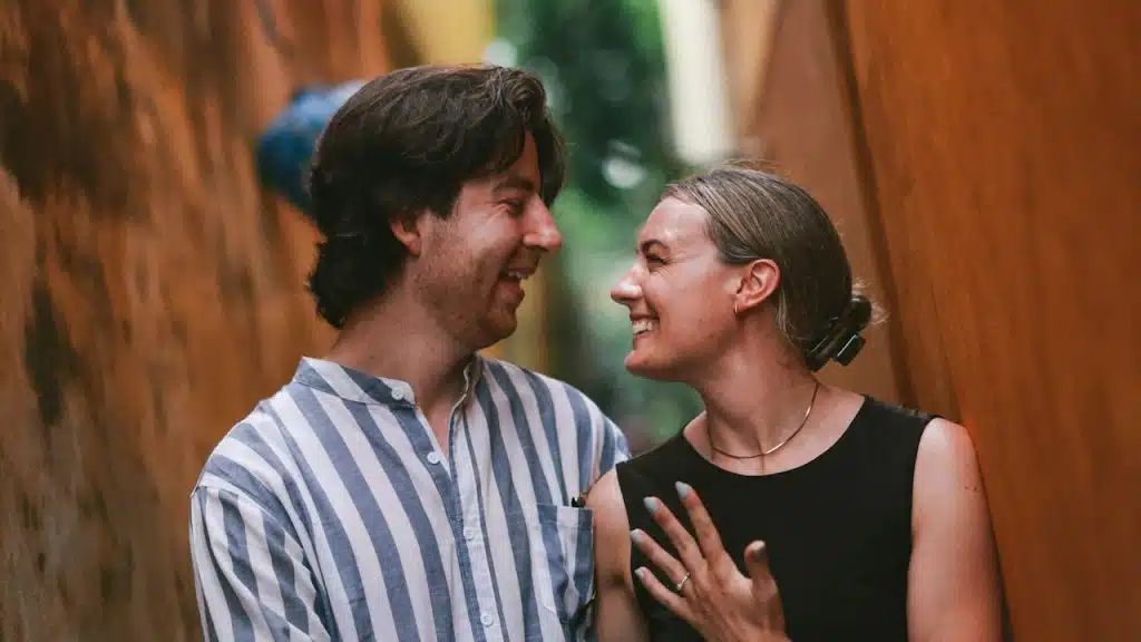 A couple smiling at each other.