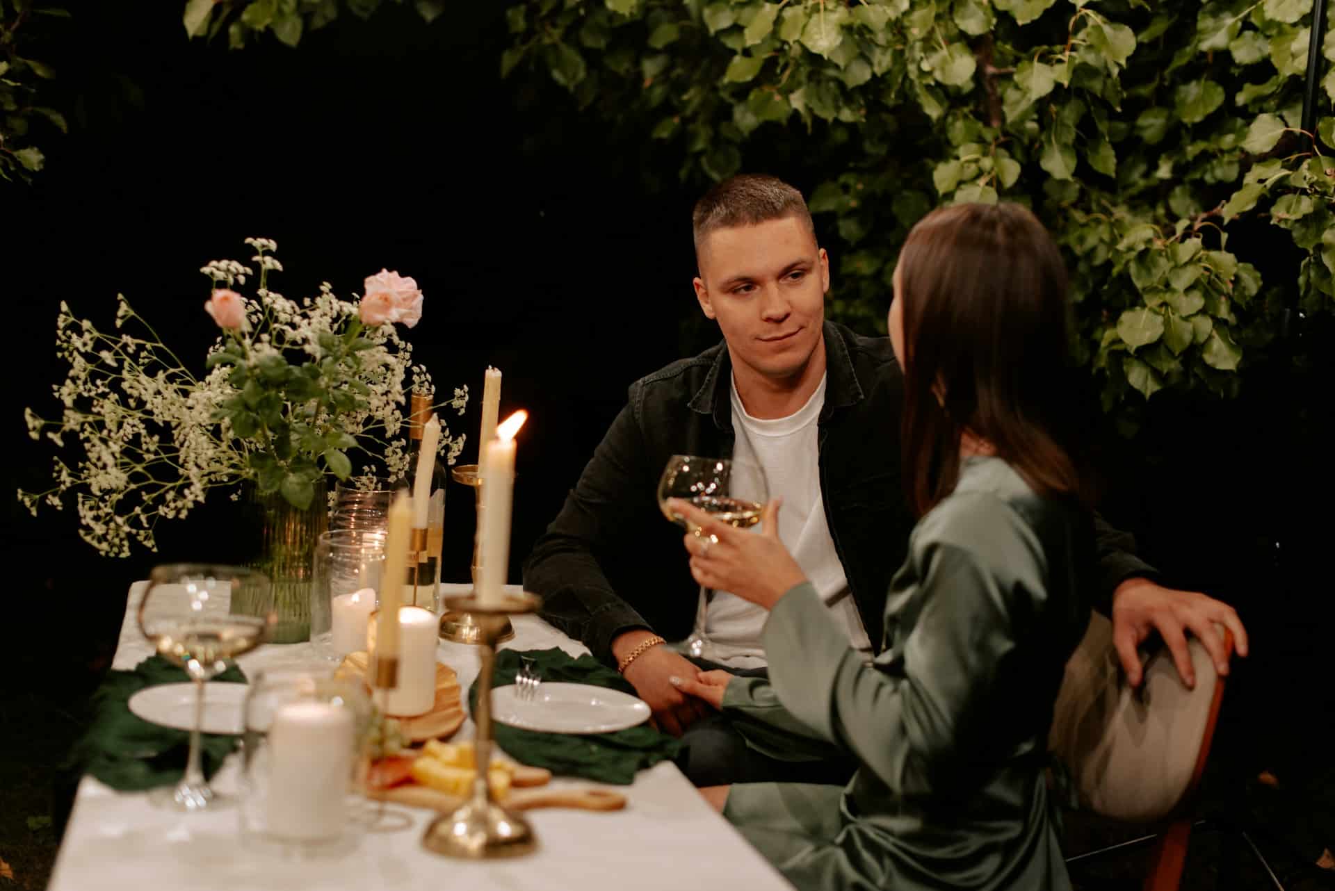 A man and a woman sitting at a dinner table.