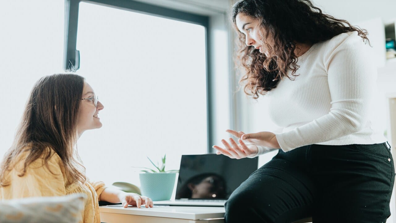 A woman explaining to her colleague