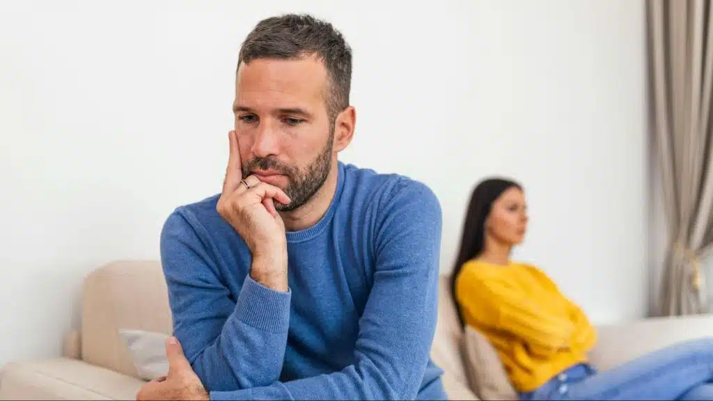 A man thinking about the woman behind him
