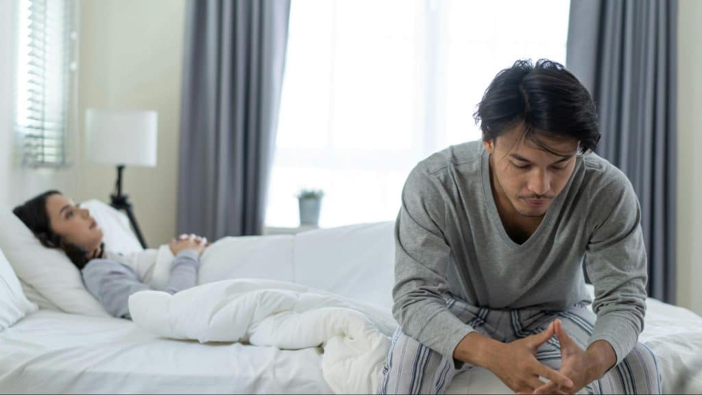 A man and woman at the bedroom