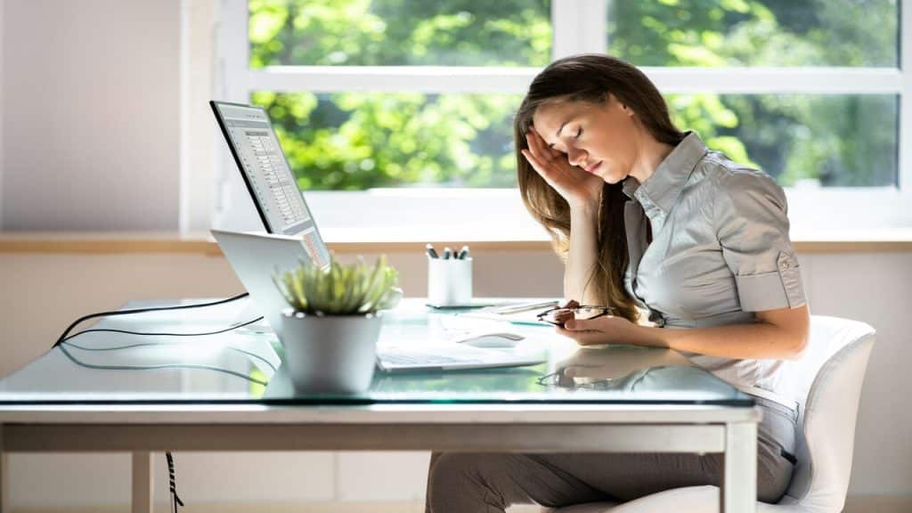 A woman looking tired while working from home