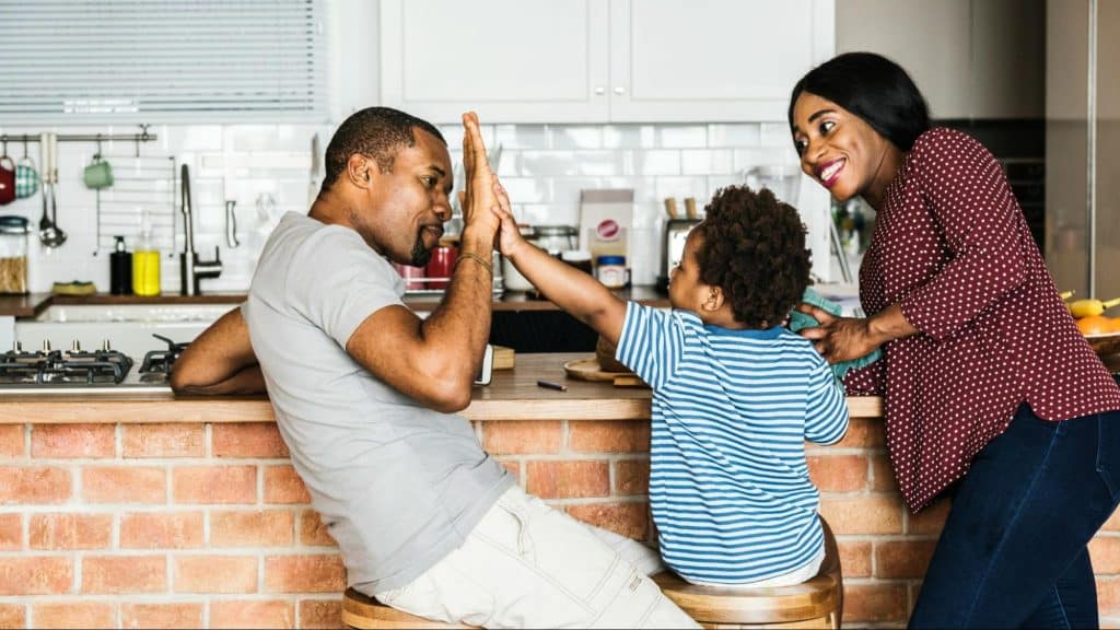 A man and woman spending time with their kid