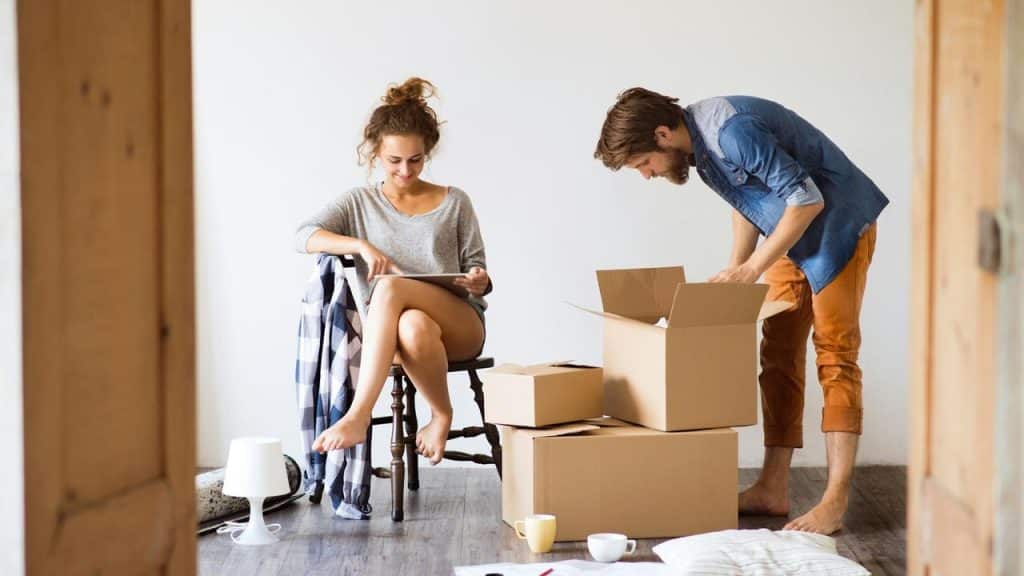 A couple unpacking boxes in a new home.