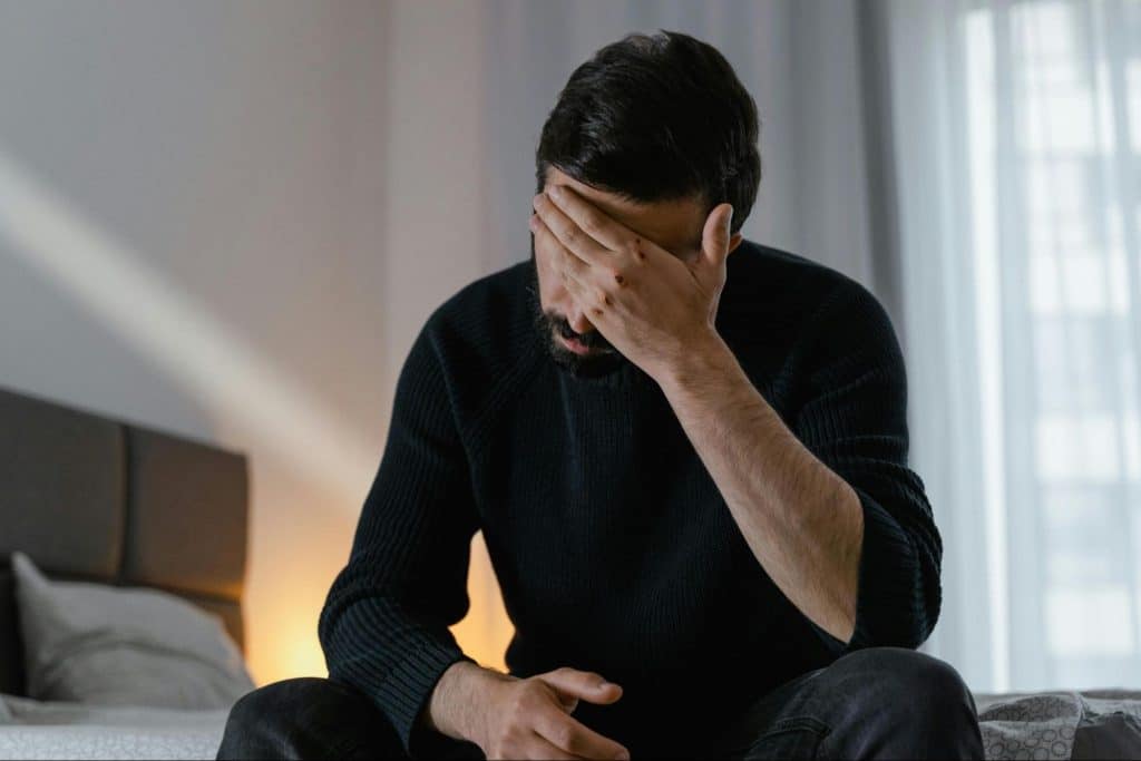 A man holding his head