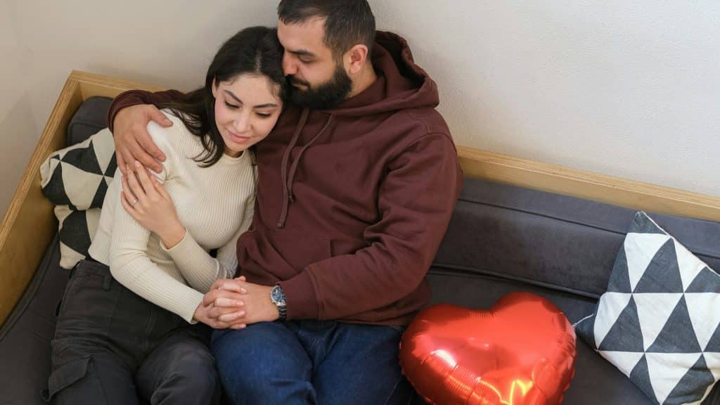 A man and a woman sitting on a couch.