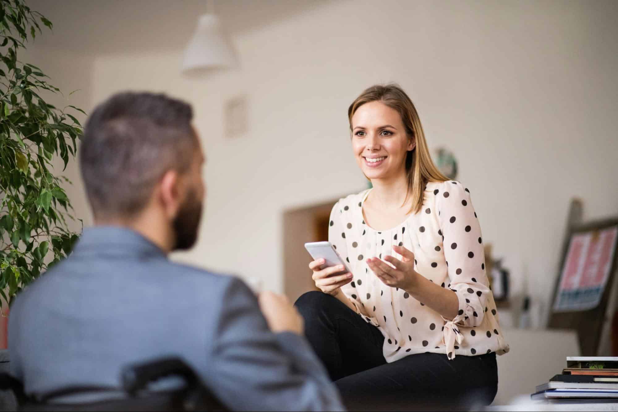 A woman listening to a man